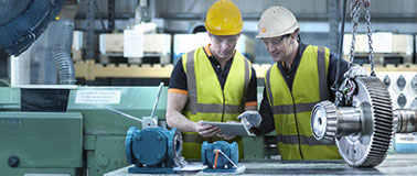 Two enginners repairing a gear set