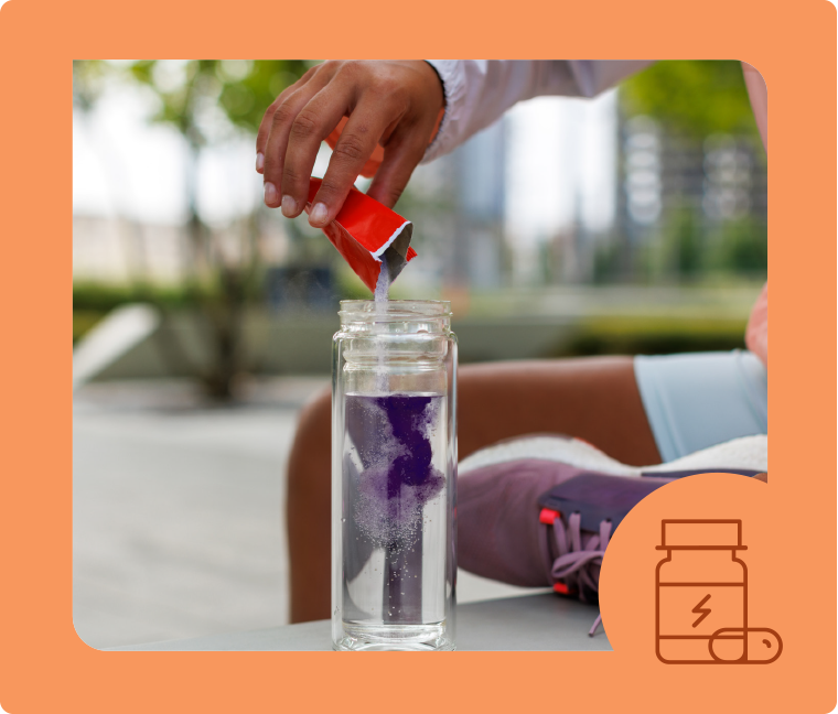 person pouring electrolytes into water bottle