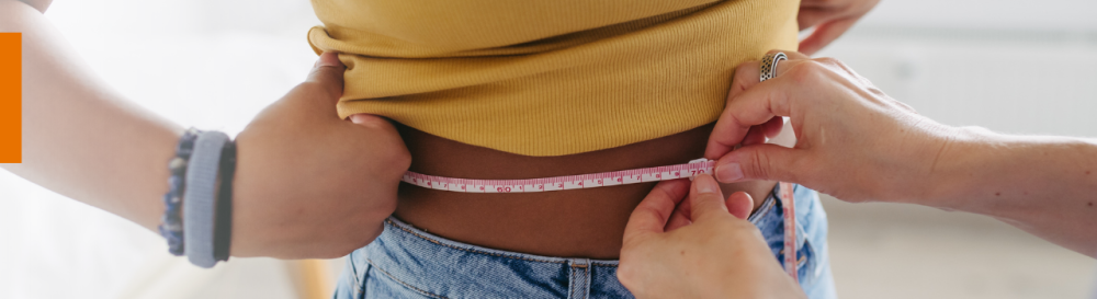 Woman being measured around their waistline