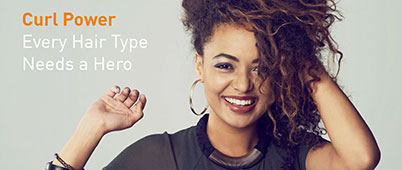 A woman with brown curly hair smiling