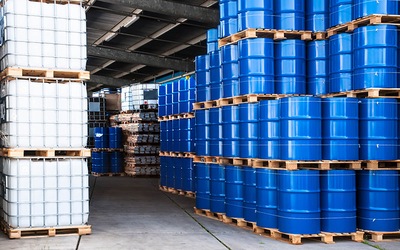 IBCs and barrels of chemicals in a warehouse