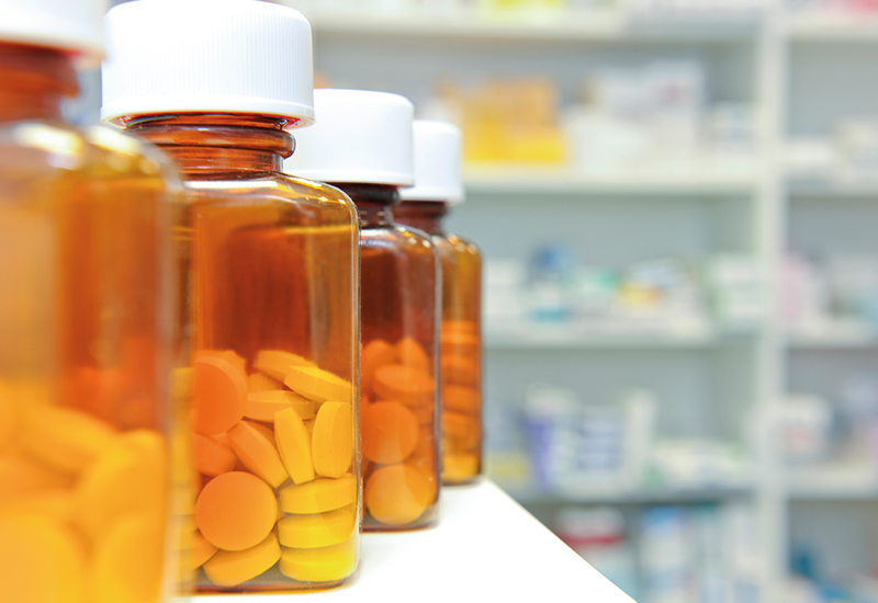 A selection of pill bottles in a pharmacy