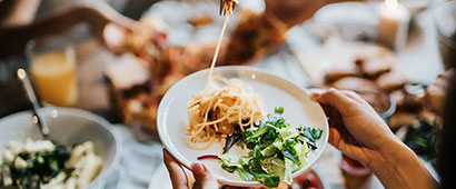 A plate of healthy pasta and salad in a restaurant