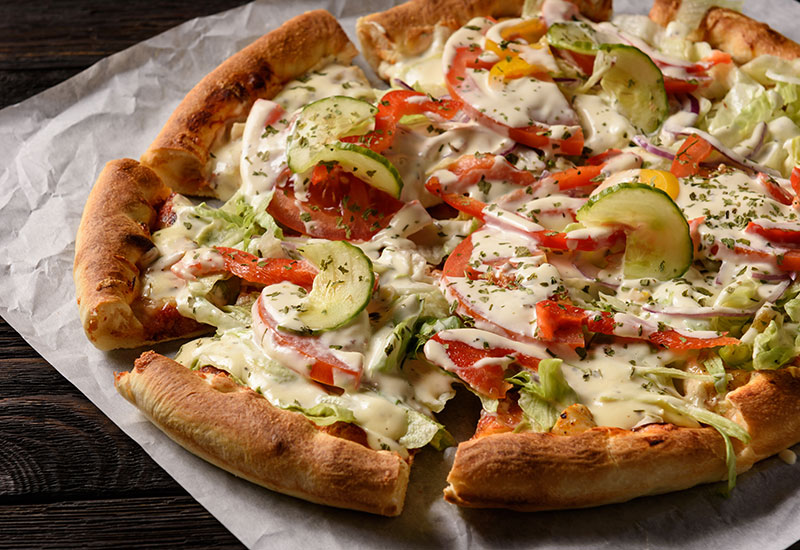 A sliced vegetable pizza