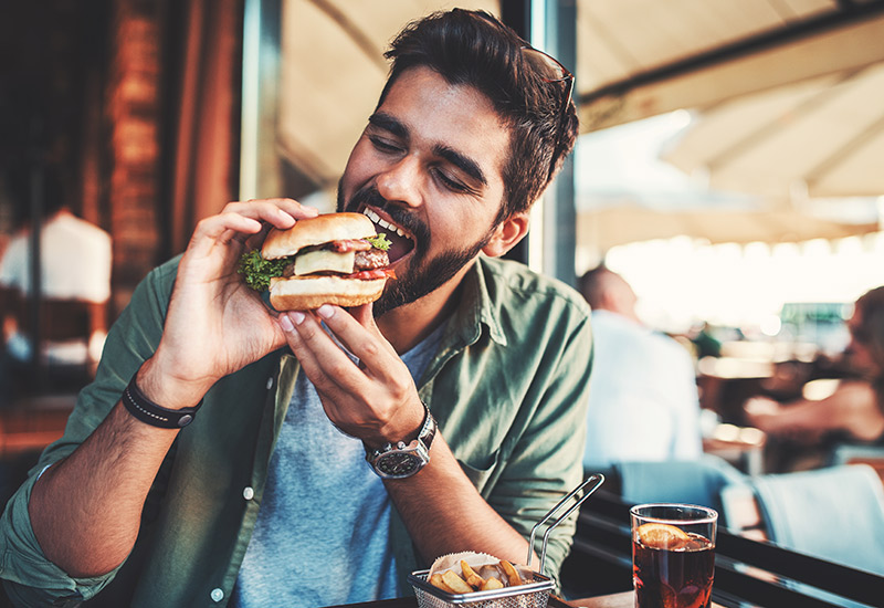 A man enjoying a plant-based burger